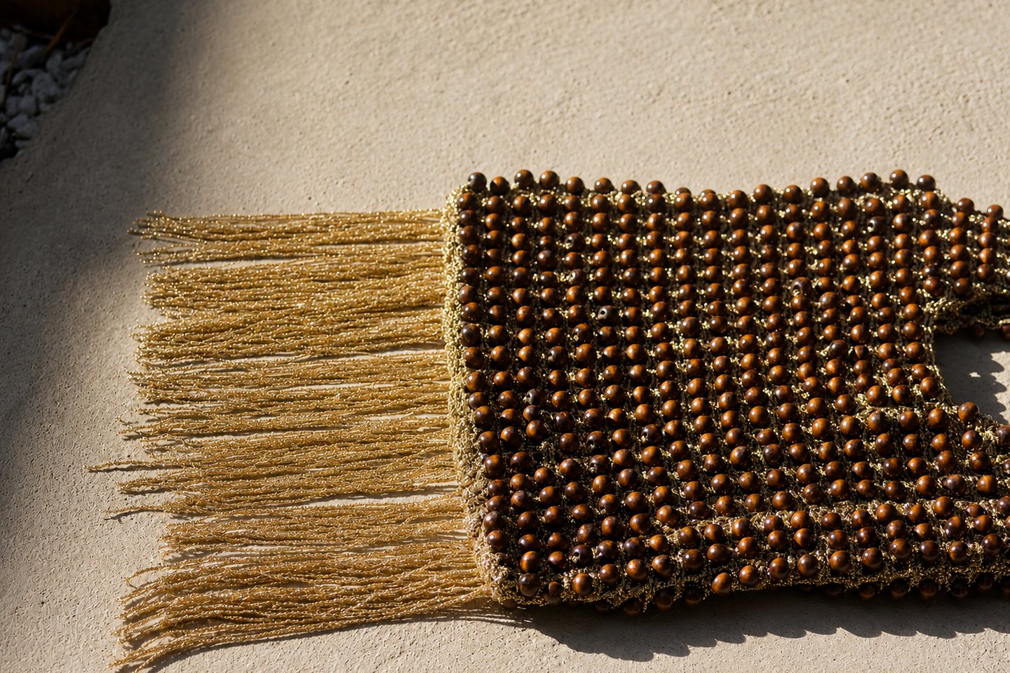 Fringe and beadwork spread across a pale stone surface.
